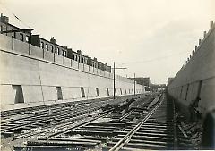 Looking east from 19th Ave. showing retaining walls, fence and roadbed