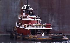 [T.T. Stuyvesant ship leaving with tugboat]