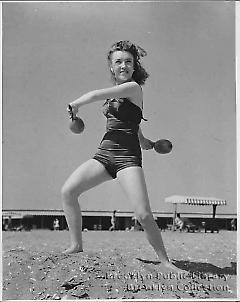 [Young woman dancing on beach]