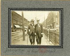 [Two men walking along a street in Brooklyn]