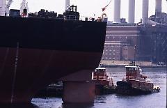 [The T.T. Stuyvesant ship leaving with tugboats]
