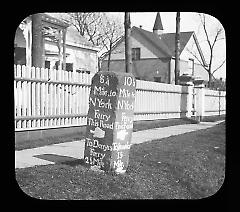 Views: U.S., Brooklyn. Brooklyn residences. View 018: Mile Stone - in front of Van Pelt Manor House. 82nd St & 18th Ave. Denyse's Ferry is now Ft. Hamilton.