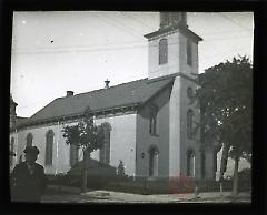 [Boy standing in front of Dutch Reformed Church, Flatbush]