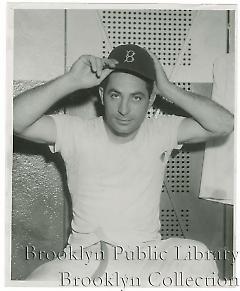 [Carl Furillo trying on baseball cap]