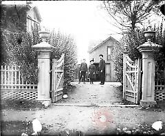 [Man and two children in driveway]