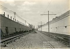 Looking west from 19th Ave. showing retaining walls, fence and roadbed