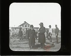 [Men standing by materials for laying railroad track, Brighton Beach]