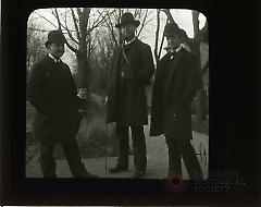 [Three men and a boy standing on sidewalk in Brooklyn]
