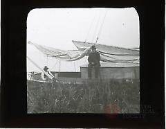 [Men sitting on sailboat]