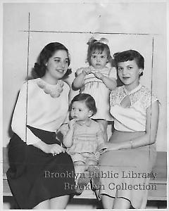 [Two young women sitting with two orphan girls]