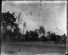 [Crowd surrounding a flagpole]