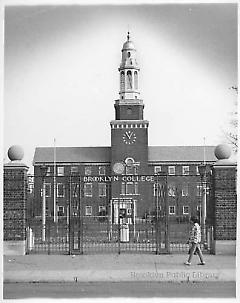 [Woman walking by closed gates of Brooklyn College]