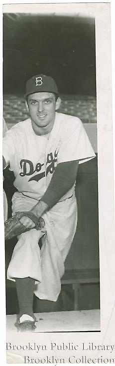 [Carl Erskine posing in dugout]